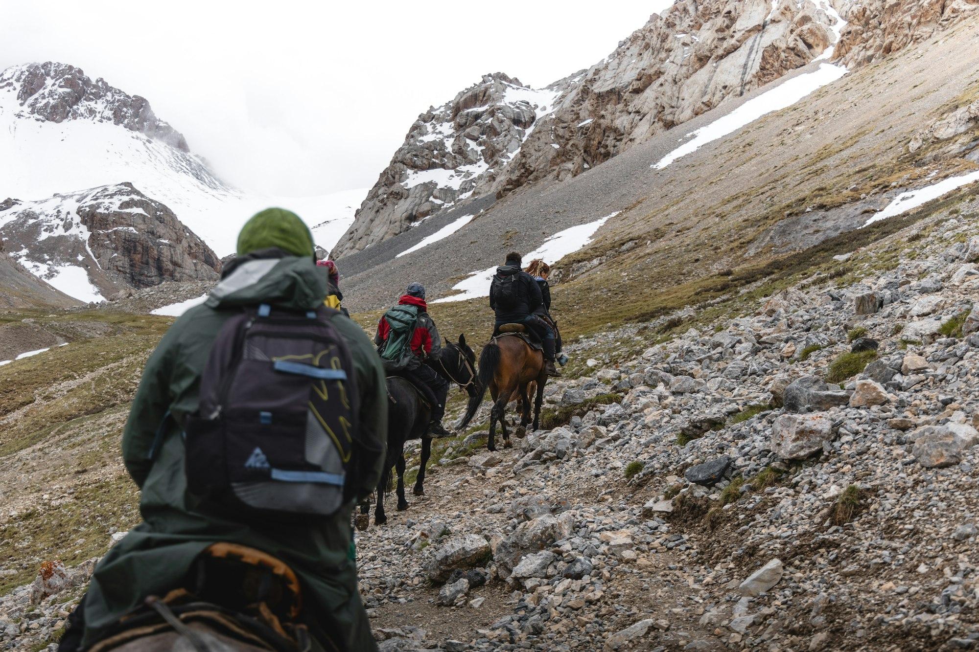 Group of riders on a rocky mountain trail — Tomáš Malík / Unsplash